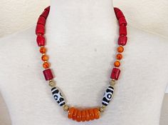 "This stunning necklace is my new favorite design! This bold beauty is not for the faint of heart!  Designed for the woman who likes to make a statement with her jewelry!  The orange and red glass beads tie the Coral and Resin together and the Black and White Accent Beads add a striking contrast to the design!  This necklace must be seen in person to really appreciate its' beauty!   Materials: Red Coral Bamboo Barrel Beads, Burnt Orange Resin Rondelles, Orange and Red Swirl Glass Beads, Acrylic One Of A Kind Red Necklace For Festival, One Of A Kind Red Jewelry For Festivals, One-of-a-kind Red Necklace For Festival, Red Coral Spiritual Necklaces, Bohemian Red Coral Necklace, Spiritual Red Coral Necklaces, Spiritual Red Coral Necklace, Traditional Red Single Strand Necklace, Red Large Beads Festival Jewelry