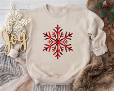 "Step into a winter wonderland with our exquisite \"Snowflake\" Sweatshirt. This elegant design captures the delicate and intricate charm of snowflakes, making it a perfect addition to your holiday wardrobe. Wearing this Sweatshirt is like wearing a piece of winter's poetry. It's a reminder of the unique and fleeting moments that make the holiday season so special. Whether you're celebrating with loved ones or simply enjoying the winter landscape, the \"Snowflake\" Sweatshirt adds a touch of ele White Holiday Sweater As Gift, White Holiday Sweater As A Gift, White Christmas Sweater As Gift, White Christmas Sweater As A Gift, White Winter Sweatshirt As A Gift, White Sweatshirt For Winter Gift, White Winter Sweatshirt For Gift, White Winter Tops As Gift, White Winter Tops As Gifts