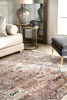 a living room filled with furniture and a large rug