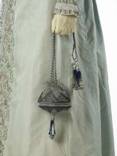 (Matching reticule detail) A pelisse or pelisse-coat, a kind of women's outer garment which could be made in everything from the lightest silk to heavy fur. It was worn over a gown but could look like a gown itself, especially when floor length like this garment. The pelisse was made for a trousseau in 1823 for the wedding of the grandmother of the donor. London Museums, Antique Clothing