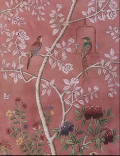 two birds are perched on the branches of a tree in front of a pink wall