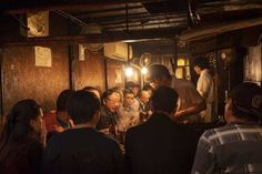 a group of people standing around a bar