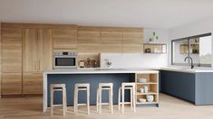 a kitchen with wooden cabinets and white counter tops, blue painted island in the middle