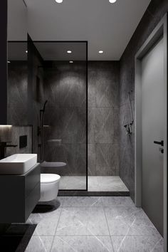 a bathroom with a toilet, sink and shower in black and white colors on the walls