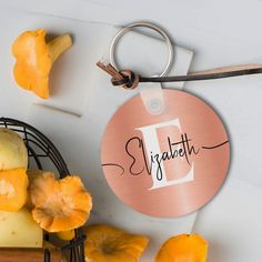 a metal tag with the letter d on it next to pineapples and other fruit