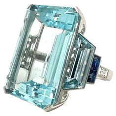 Platinum ring with 24.12 carat aquamarine, 0.27 carat diamond , 0.24 carat sapphire and 0.27 carat aquamarine. Sophia D by Joseph Dardashti LTD has been known worldwide for 35 years and are inspired by classic Art Deco design that merges with modern manufacturing techniques. Aquamarine Ring, Ring Art Deco, Perfect Harmony, Aquamarine Rings, Platinum Ring, Gem Stone, Art Deco Design, Cocktail Rings, 40 Years