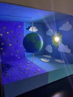 a blue room with a green globe and stars on it