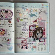 an open planner with stickers and pictures on the pages is shown in this image