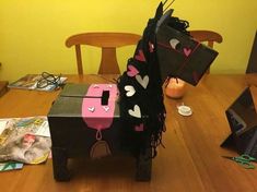 a horse made out of paper sitting on top of a wooden table