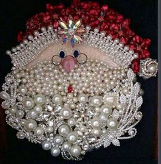 a santa clause made out of pearls and jewels