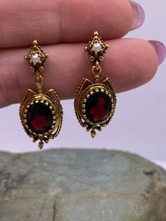 "Antique Victorian 14k Yellow Gold Garnet and Pearl Chandelier Dangle Post Earrings 1 1/3\" (1004). Marked 14k. Condition is very good, but the stones do have some slight pitting, light tarnish, light scuffs and scratches. Thank you for looking! Prices on shop items are fair and reasonable, so all prices are firm.  No reserves all items sold as-is. Please review photos and description carefully before purchasing.  Please let me know if you have any questions or special shipping requests such as Garnet Wedding Jewelry, Antique Victorian Jewelry, Gold Vintage Earrings, Red And Gold Jewelry, Victorian Gold Earrings, Old Earrings, Vintage Gold Jewelry, Gold Dangling Earrings, Garnet And Pearl