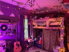 a bedroom with purple lighting and decorations on the ceiling, bunk beds are decorated with string lights