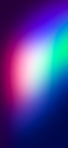 a blurry image of the colors of blue, green, pink and purple on a black background