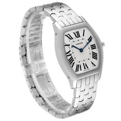 Cartier Tortue 18k White Gold Silver Dial Ladies Watch 3701 Box Papers. Manual winding movement. 18K white gold case 31.0 x 39.0 mm. Octagonal crown set with the blue cabochon. 18K white gold bezel. Scratch resistant sapphire crystal. Silver sunray silver dial with roman numerals. Blue sword shape hands. Secret signature at VII. 18k white gold bracelet with double deployant buckle.  Fits 7 1/4" wrist. Classic Cartier Watch Gift, Cartier White Watch With Rectangular Dial, Cartier White Business Watch, Cartier White Watch For Formal Occasions, White Cartier Watch For Formal Occasions, Cartier White Watch Accessories For Formal Occasions, Elegant White Cartier Watch Accessories, Formal White Cartier Watch, Classic Platinum Watches As Gift