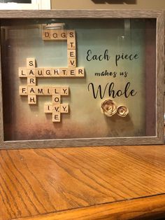 a wooden frame with scrabbles and words written on it that says each piece makes us whole