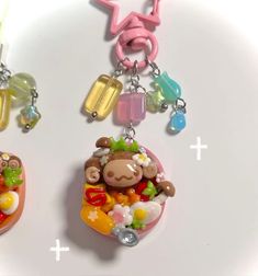 two necklaces with charms attached to them