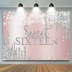 a pink and silver glittered wall with lights above it that says, sweet sixteen