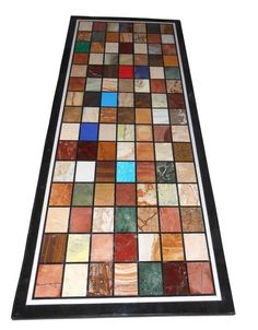 a multicolored glass tile table top with black frame and white border around the edges