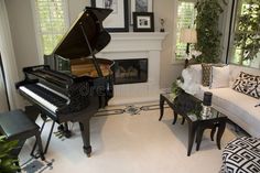 a living room filled with furniture and a piano