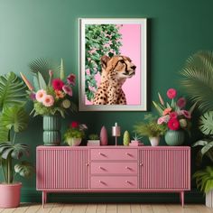 a cheetah sitting on top of a pink dresser next to potted plants