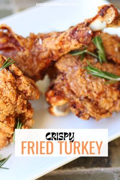 crispy fried turkey on a white plate with rosemary garnish and the words crispy fried turkey above it