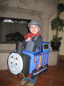 a young boy in a thomas the tank engine costume