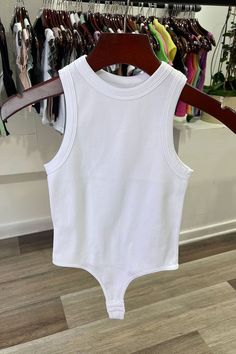 The White Tank Rib Bodysuit is perfect for a night out. Crafted with a ribbed fabric and cut for a body-hugging fit, this bodysuit will keep you looking stylish and feeling comfortable all night long. The tank ribbed design fits snug to your figure, making a sleek statement. Complete your look with a pair of jeans or a skirt for a night of fun. Fabric & fit: 92% nylon 8% spandex Model is wearing size Small. Summer High Stretch Ribbed Tank Top, Cotton Ribbed Solid Bodysuit, Cotton Ribbed Solid Color Bodysuit, Sleeveless Ribbed Bodysuit For Night Out, Stretch Ribbed Cotton Bodysuit, Trendy Fitted Ribbed Bodysuit, Spring Cotton Ribbed Bodysuit, Chic Ribbed Bodysuit For Night Out, Fitted White Tank Bodysuit