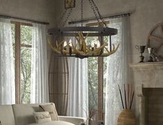 a chandelier with antlers hanging from it's sides in a living room