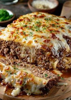 meatloaf with cheese and sauce on a cutting board