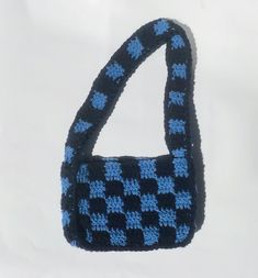 "This hand-crocheted shoulder bag features a blue and navy checkered print throughout the entire bag. Made in Canada. Measurements: 8\" x 6 x 2\"" Trendy Blue Crochet Bags, Trendy Navy Rectangular Shoulder Bag, Blue Crochet Shoulder Bag, Trendy Blue Crochet Bag For Everyday, Trendy Blue Crochet Bag For Everyday Use, Blue Square Crochet Bags, Blue Crochet Shoulder Bag For Everyday, Blue Square Shoulder Bag For School, Blue Square Crochet Bag For Everyday