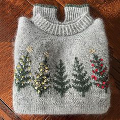 a gray sweater with christmas trees on it