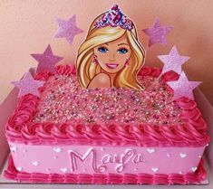 a barbie birthday cake with pink frosting and stars