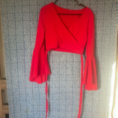 Red Crop Top With Flared Sleeves Has Strong To Tie Around Torso Never Worn But Does Have A Couple Marks On The Back As Pictured Red Fitted V-neck Top, Red Stretch Long Sleeve Crop Top, Red Long Sleeve Stretch Crop Top, Casual Wrap Top For Party, Party V-neck Crop Top, Red Fitted Crop Top For Fall, Red V-neck Crop Top For Spring, Fitted Red Crop Top For Fall, Fitted Red Long Sleeve Crop Top