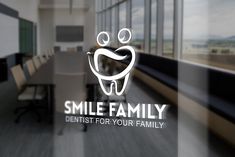 the logo for a dentist's office is seen through a glass door in front of a meeting room