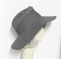 "Wide Brim Sun Hat grey striped two tone Inside black cotton band, the hat has a 2 section crown 3 1/2 \" in length and a one piece 4\" brim, and is lined in a cotton blend print. Each hat is unique with repurposed grey cotton twill making each hat vary. This hat is one size fits all and will fit 21\" - 23\" head size. All of Bella Starr hats are made and designed from my drafted original patterns. Caring for your hat: Machine wash gentle & hand dry Wide Brim can be folded for travel Caring Wide Brim Sun Hat, Wide Brimmed Hats, Brim Hat, Grey Cotton, Sun Hat, Wide Brimmed, Soft Black, Grey Stripes, Head Wraps