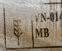 a close up of the initials on a wooden surface