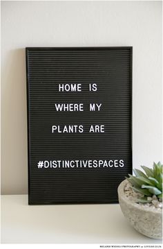 a sign that says home is where my plants are distinctive livespaces on it