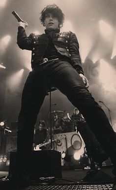 an image of a man on stage with his guitar