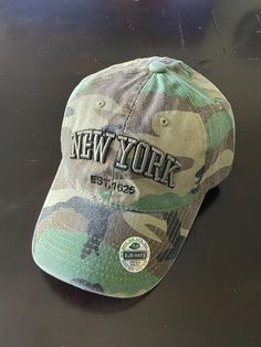 Step into timeless style with this Cameo Vintage New York Embroidered Baseball Hat. Crafted with a blend of retro charm and modern flair, this hat features intricate embroidery of the iconic New York lettering, adding a touch of vintage appeal to any outfit. The soft, washed fabric gives it a comfortable, worn-in look, perfect for casual wear or a day out in the city. With an adjustable strap, this hat fits all sizes, ensuring a snug and secure fit for every adventure. Whether you're a New York native or just love the city's vibe, this hat is a must-have accessory for a laid-back, stylish look. -Material: 100% cotton -Fit: Adjustable strap -Style: Unisex, vintage-inspired -Color: Classic cameo with embroidered New York lettering -Perfect for: Everyday wear, street style, and vintage fashio Hat New York, Ny Baseball, Ladies Hats, Hats Summer, Hat Fits, Denim Hat, Embroidered Baseball, Vintage Hats, Vintage New York