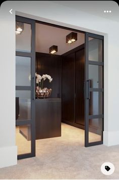 an open door leading into a room with white walls and carpeted flooring in front of it