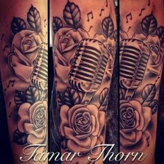 a tattoo with roses and a microphone on it