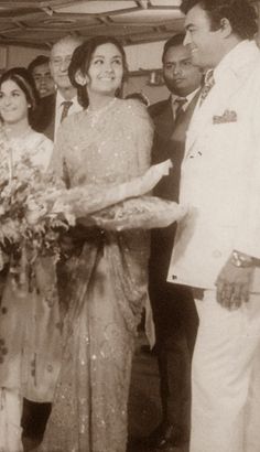 an old black and white photo of a couple being married to a man in a suit