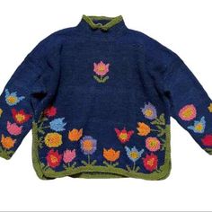 a blue sweater with colorful flowers on it