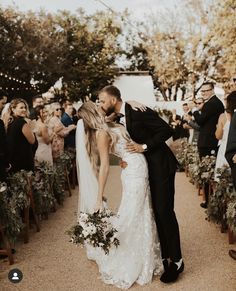 a bride and groom kissing at their wedding ceremony