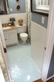 a white toilet sitting in a bathroom next to a sink