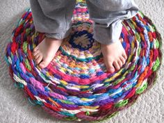 a person standing on top of a multicolored rug