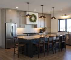 a large kitchen with an island in the middle