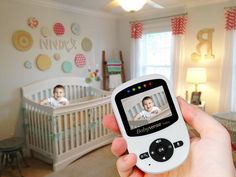 a person is holding up a video baby monitor