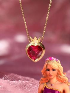 a barbie doll wearing a tiara with a heart shaped necklace