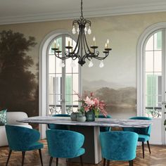 a dining room table with blue chairs and a chandelier